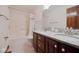 Bathroom with double sink vanity, granite counters, and a shower tub at 5139 Kingswood Dr, Carmel, IN 46033