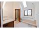 Bright bathroom with skylight, soaking tub, glass shower, and granite countertop vanity at 5139 Kingswood Dr, Carmel, IN 46033