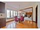 Charming dining area featuring a bay window with seating and hardwood floors, open to the living room at 5139 Kingswood Dr, Carmel, IN 46033