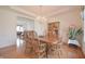 Well-lit dining area with wood floors, table and chairs as well as a view into the Gathering room at 5139 Kingswood Dr, Carmel, IN 46033