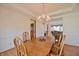 Light filled dining room showcasing wood table, chairs and flooring with a view into the Gathering room at 5139 Kingswood Dr, Carmel, IN 46033