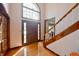 Inviting foyer with a soaring window, hardwood floors, and elegant staircase at 5139 Kingswood Dr, Carmel, IN 46033