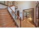 Elegant foyer with hardwood floors, staircase, and access to a private office at 5139 Kingswood Dr, Carmel, IN 46033