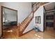 Open foyer with wood floors, staircase, and views to the living room and kitchen at 5139 Kingswood Dr, Carmel, IN 46033