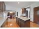 Open concept kitchen with granite countertops, wood cabinets, hardwood floors, and stainless steel appliances at 5139 Kingswood Dr, Carmel, IN 46033