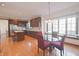 Gourmet kitchen with stainless steel appliances, a breakfast nook, wood cabinets, and hardwood floors at 5139 Kingswood Dr, Carmel, IN 46033
