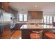 Contemporary kitchen with granite countertops, wood cabinets, hardwood floors, and stainless steel appliances at 5139 Kingswood Dr, Carmel, IN 46033