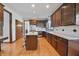 Well-equipped kitchen with granite countertops, wood cabinets, stainless steel appliances and hardwood floors at 5139 Kingswood Dr, Carmel, IN 46033