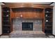 Living room featuring a brick fireplace, built-in shelving, and wood trim at 5139 Kingswood Dr, Carmel, IN 46033