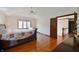 Well-lit main bedroom with hardwood floors and a view into the hallway at 5139 Kingswood Dr, Carmel, IN 46033