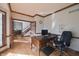 Home office with dark wood trim, built-ins, and lots of natural light at 5139 Kingswood Dr, Carmel, IN 46033