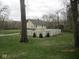 A two-story home with a white fence and landscaping at 5657 E Fall Creek Pkwy N Dr, Indianapolis, IN 46226
