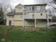 A two-story house with a deck and a green lawn at 5657 E Fall Creek Pkwy N Dr, Indianapolis, IN 46226