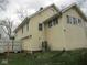 The side of a two-story house with a grassy yard at 5657 E Fall Creek Pkwy N Dr, Indianapolis, IN 46226