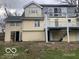 View of the back of the home with an elevated deck and siding in need of repair at 5657 E Fall Creek Pkwy N Dr, Indianapolis, IN 46226