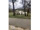 View of the rear of the home with a backyard and a partially finished privacy fence at 5657 E Fall Creek Pkwy N Dr, Indianapolis, IN 46226