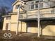 View of the home's backyard with an elevated deck and siding in need of repair at 5657 E Fall Creek Pkwy N Dr, Indianapolis, IN 46226