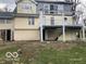 View of the back of the home with an elevated deck and siding in need of repair at 5657 E Fall Creek Pkwy N Dr, Indianapolis, IN 46226