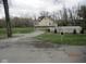 A house with a two-story deck and a long driveway at 5657 E Fall Creek Pkwy N Dr, Indianapolis, IN 46226