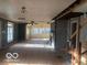 Wide angle view of living room renovation with exposed walls, hardwood floors and natural light at 5657 E Fall Creek Pkwy N Dr, Indianapolis, IN 46226