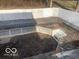An in-ground pool sits ready for renovation and is surrounded by a white fence and space for entertaining at 5657 E Fall Creek Pkwy N Dr, Indianapolis, IN 46226