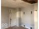 Interior view of a room with neutral paint, an open door, and vent fixtures on the wall at 5657 E Fall Creek Pkwy N Dr, Indianapolis, IN 46226