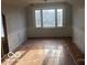 Empty room featuring hardwood flooring and paneled walls ready for customization at 5657 E Fall Creek Pkwy N Dr, Indianapolis, IN 46226