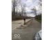 Street view of the property featuring nearby trees and greenery, offering a tranquil and accessible location at 5657 E Fall Creek Pkwy N Dr, Indianapolis, IN 46226