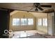 Sunroom with exposed framing, unfinished walls, and multiple windows providing natural light at 5657 E Fall Creek Pkwy N Dr, Indianapolis, IN 46226