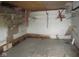 An unfinished room with shelves and a damaged ceiling at 5657 E Fall Creek Pkwy N Dr, Indianapolis, IN 46226
