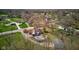 This aerial shot showcases a home with a pool and deck surrounded by mature trees and greenery at 6170 Shelbyville Rd, Indianapolis, IN 46237