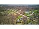 Expansive aerial view of a rural property with lush greenery, a pond, and multiple homes at 6170 Shelbyville Rd, Indianapolis, IN 46237