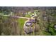 A scenic aerial captures a home with a pool, nestled among trees and a well-maintained landscape at 6170 Shelbyville Rd, Indianapolis, IN 46237