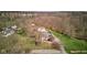 Sprawling property with a pool and outbuilding surrounded by a lush landscape with mature trees at 6170 Shelbyville Rd, Indianapolis, IN 46237