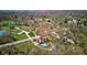 An aerial view features a property with a pool, several buildings, and a mix of trees and grass at 6170 Shelbyville Rd, Indianapolis, IN 46237