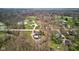 Aerial view of a home with a pool and lush green landscape surrounded by mature trees, and neighboring properties at 6170 Shelbyville Rd, Indianapolis, IN 46237