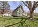 Exterior angle of home highlighting the spacious backyard and stone exterior finish at 6170 Shelbyville Rd, Indianapolis, IN 46237