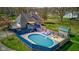 Charming backyard features a pool with a wooden deck, patio furniture, and a well-maintained lawn at 6170 Shelbyville Rd, Indianapolis, IN 46237