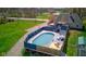 Inviting backyard pool area featuring a deck, lounge seating, and a covered patio for relaxation at 6170 Shelbyville Rd, Indianapolis, IN 46237