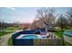 A well-maintained in-ground pool highlights the property with an adjacent deck and patio furniture at 6170 Shelbyville Rd, Indianapolis, IN 46237