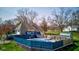 Attractive home exterior highlighting the fenced backyard pool, stone siding, and outdoor lounge area at 6170 Shelbyville Rd, Indianapolis, IN 46237