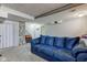 Spacious finished basement with carpeting and a comfortable blue sofa, plus stone accent wall at 6170 Shelbyville Rd, Indianapolis, IN 46237