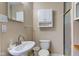A bathroom with a pedestal sink, toilet, and glass-enclosed shower at 6170 Shelbyville Rd, Indianapolis, IN 46237