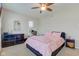 Comfortable bedroom with pink floral bedding, ceiling fan and plenty of natural light at 6170 Shelbyville Rd, Indianapolis, IN 46237