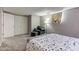 Cozy bedroom with carpeted floors and soft natural light with a chair and ottoman at 6170 Shelbyville Rd, Indianapolis, IN 46237
