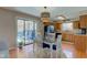 Open dining area featuring stylish light fixtures, and access to the kitchen and backyard patio at 6170 Shelbyville Rd, Indianapolis, IN 46237