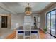 Dining room with a table and four chairs set upon an area rug, next to a washer and dryer at 6170 Shelbyville Rd, Indianapolis, IN 46237