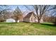 Charming stone home with mature trees, lush lawn, and detached garage, perfect for countryside living at 6170 Shelbyville Rd, Indianapolis, IN 46237