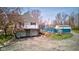 Two-story home features a balcony, garage, and well-maintained yard with a shed and landscaping at 6170 Shelbyville Rd, Indianapolis, IN 46237