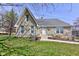 Charming stone home featuring a well-maintained front yard and inviting walkway at 6170 Shelbyville Rd, Indianapolis, IN 46237